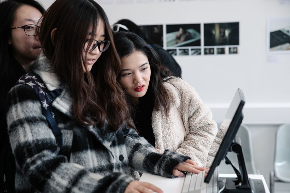 students looking over screen