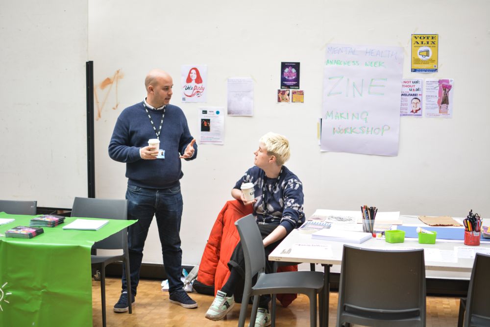 staff sitting at a zine making table