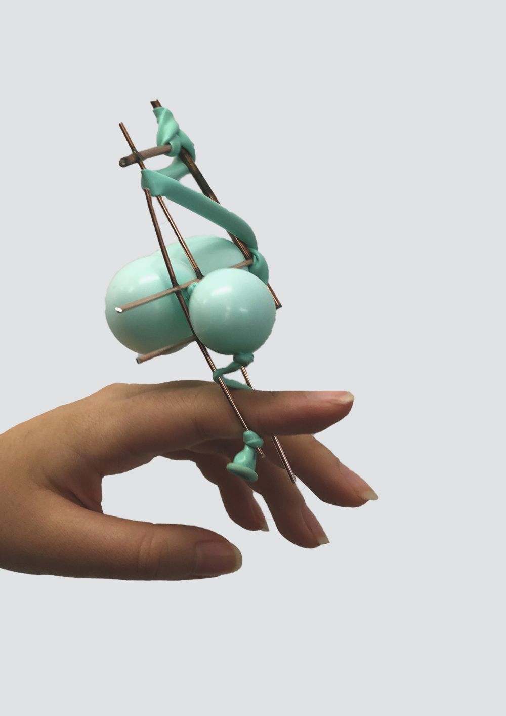Metal and rubber object entwined on fingers