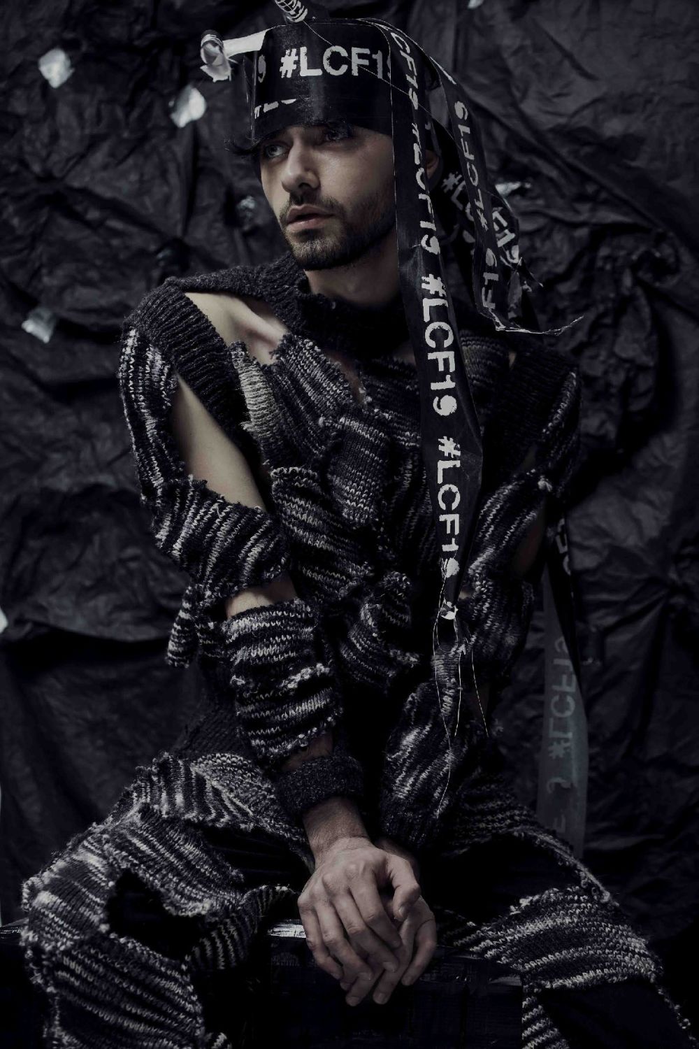 A model wears textiles and a long head-dress marked with LCF19.