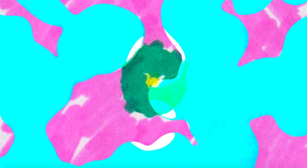 A motion still in which blue and pink bubbles pop to reveal flickering, colourful doodles.