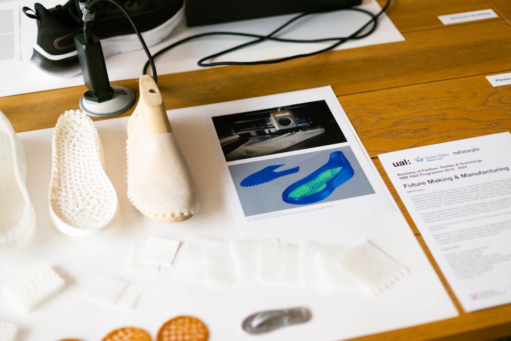 A close up photograph of a work station with product prototype and paper with information and sketches