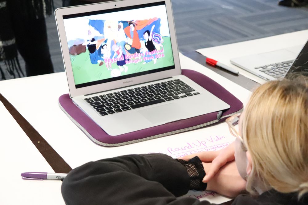 Student looking at illustrative design on laptop screen