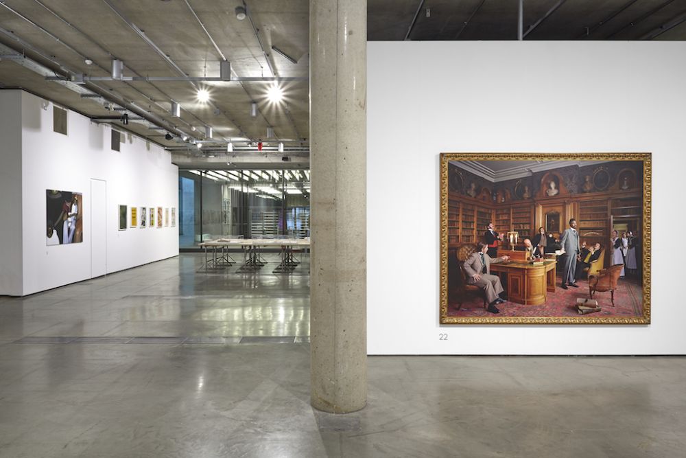 image of gallery from one end, showing a large photo of yinka shonibare as a dandy in a stately home, the other images are out of shot