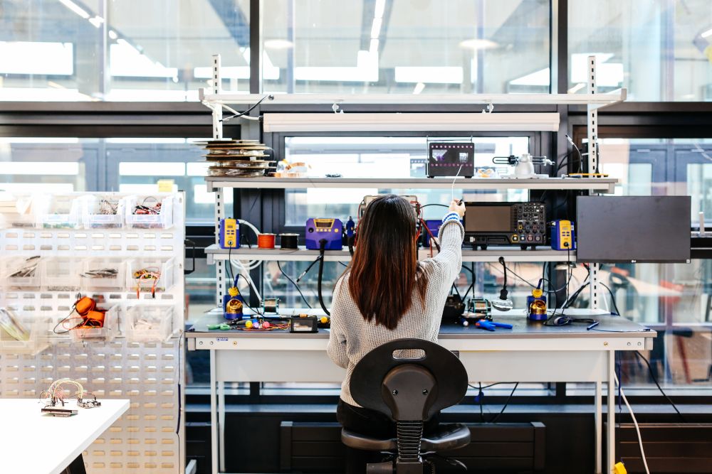 View of Anna from behind as she work at her station in the Creative Computing Institute.