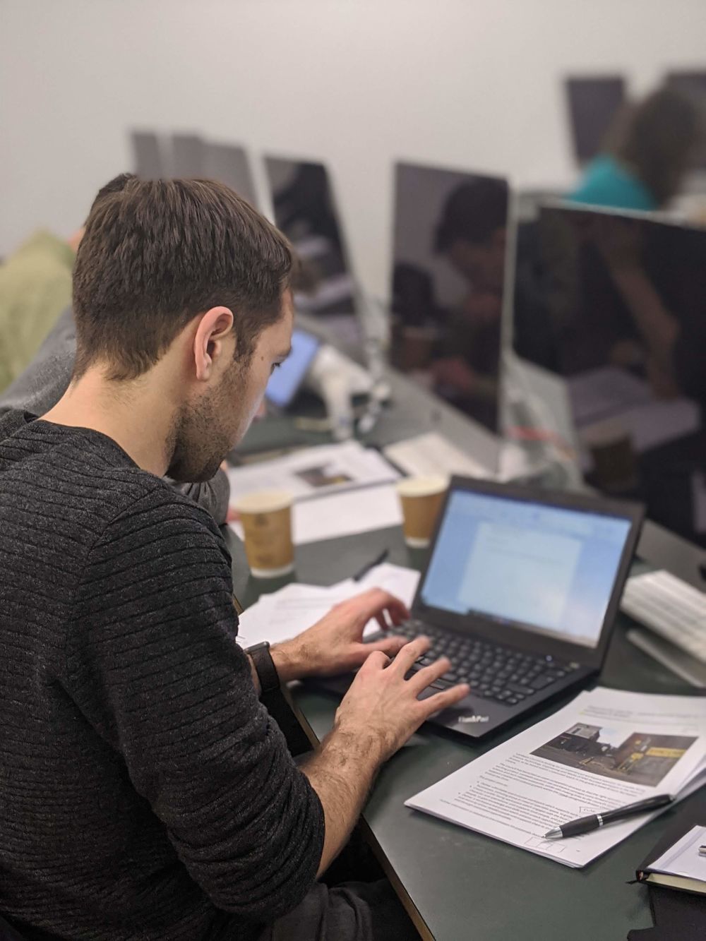 man typing on laptop