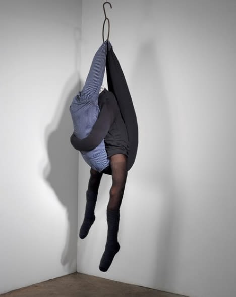 A sculpture of two fabric bodies embracing