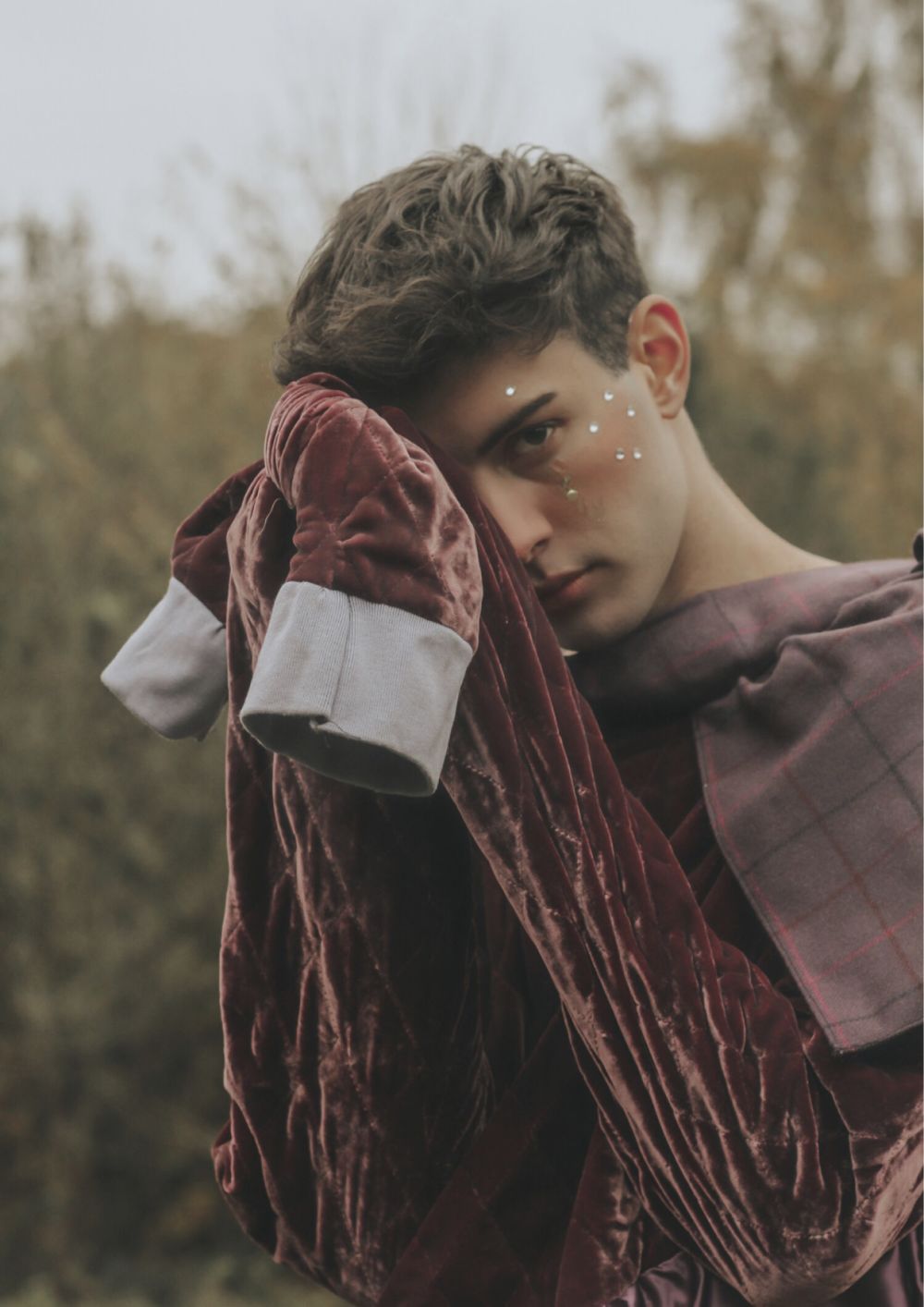 Image of model in burgundy velvet sleeves.
