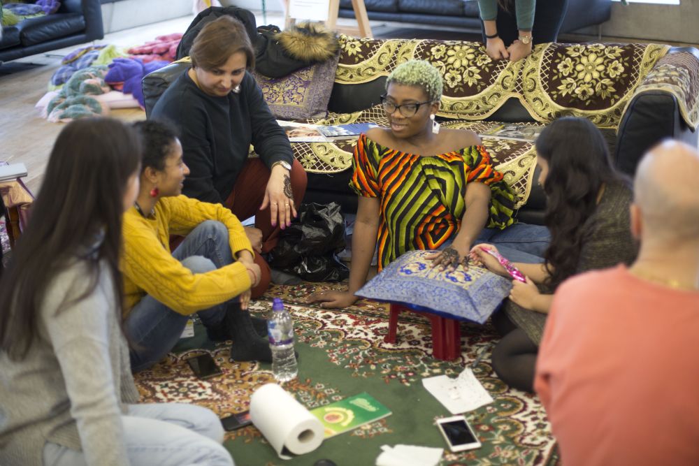 Women having henna applied to her hands