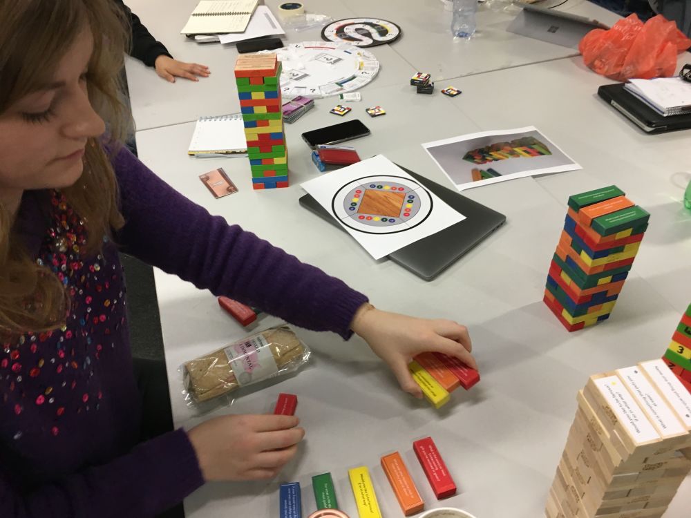People sitting with coloured blocks on table