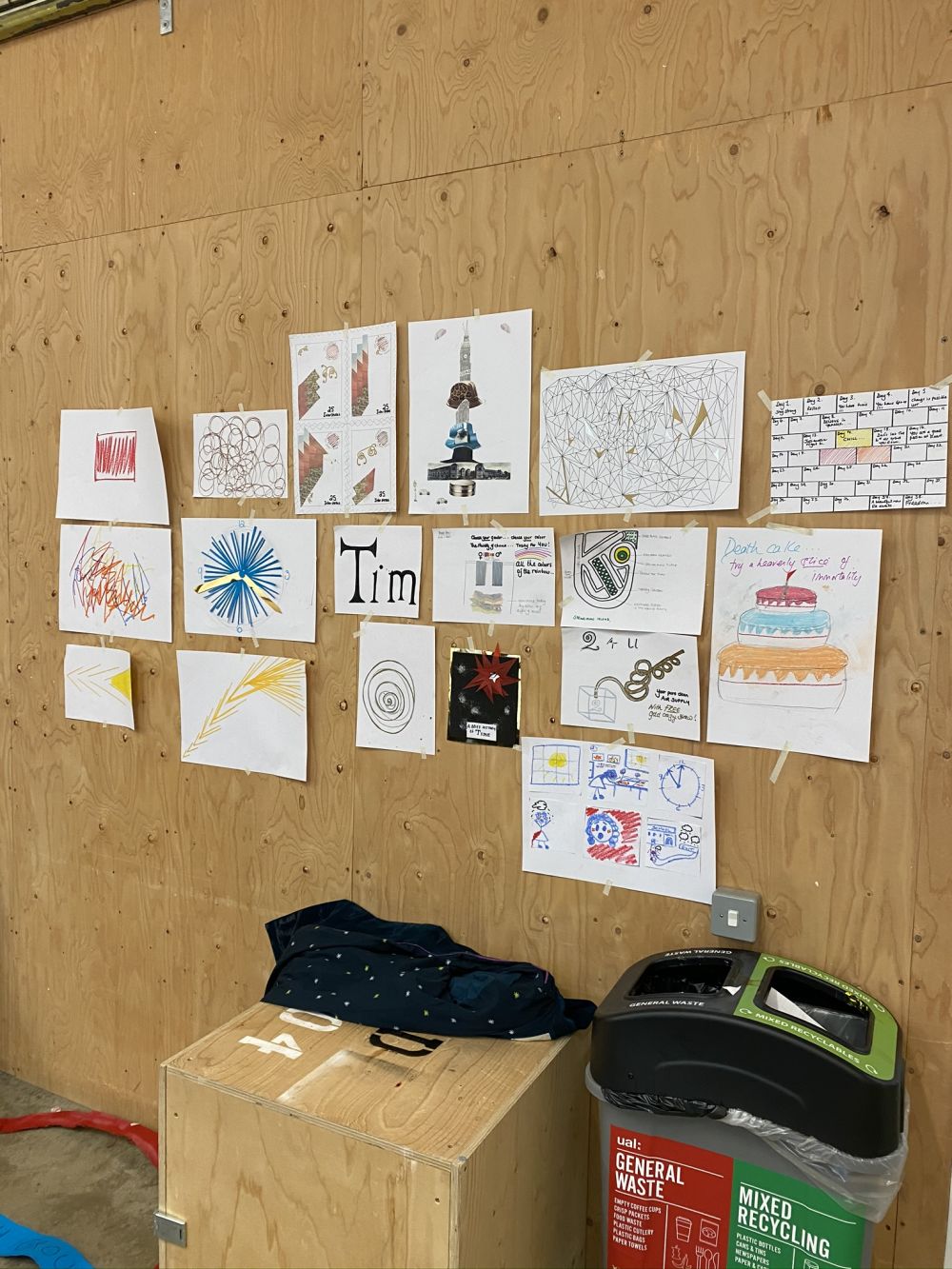 Different illustrations and drawings done on paper stuck up on the wall