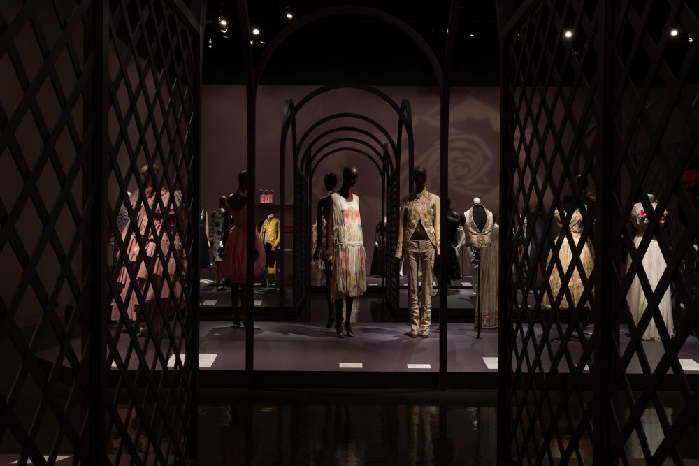 exhibition display of rose themed dresses