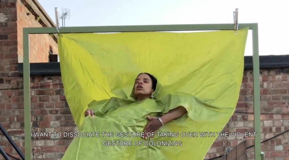 Woman's face emerging from green fabric