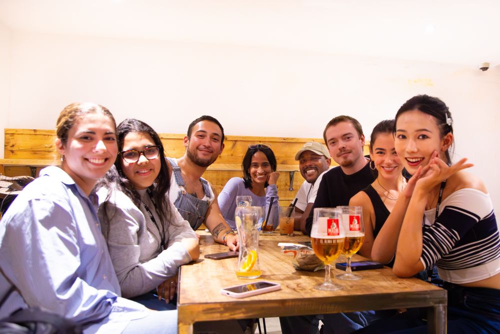 Group of students gathered around a bar table