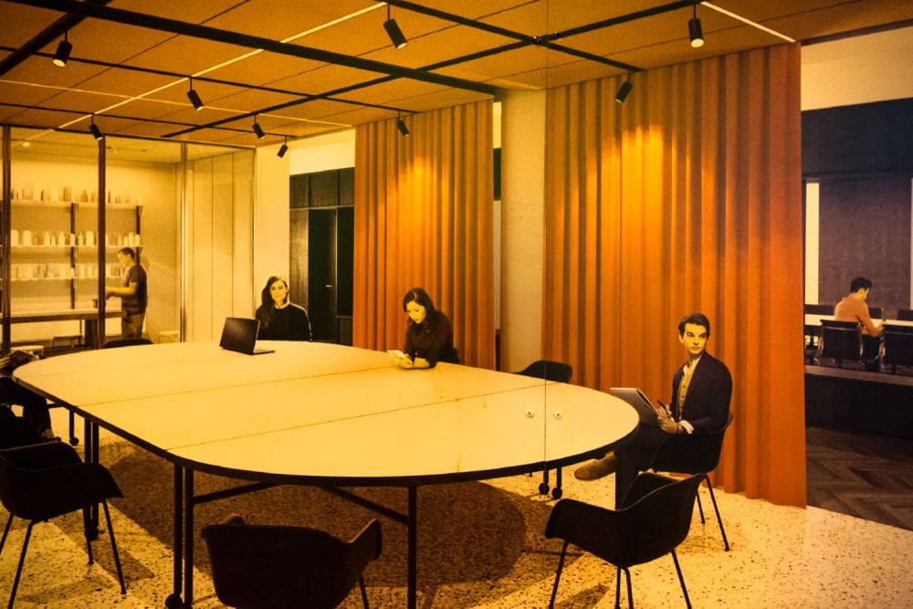 People sat around corporate looking boardroom.