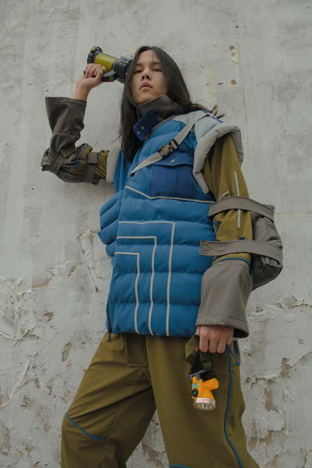 Model wearing blue jacket and khaki trousers