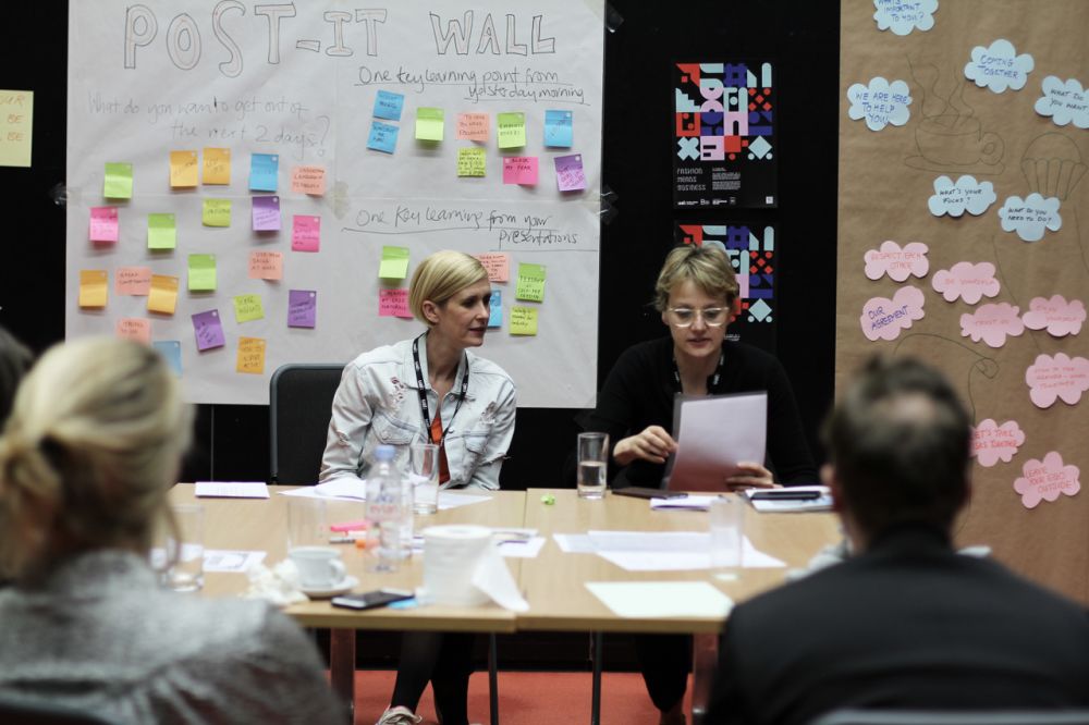 Tutors running a workshop from a table