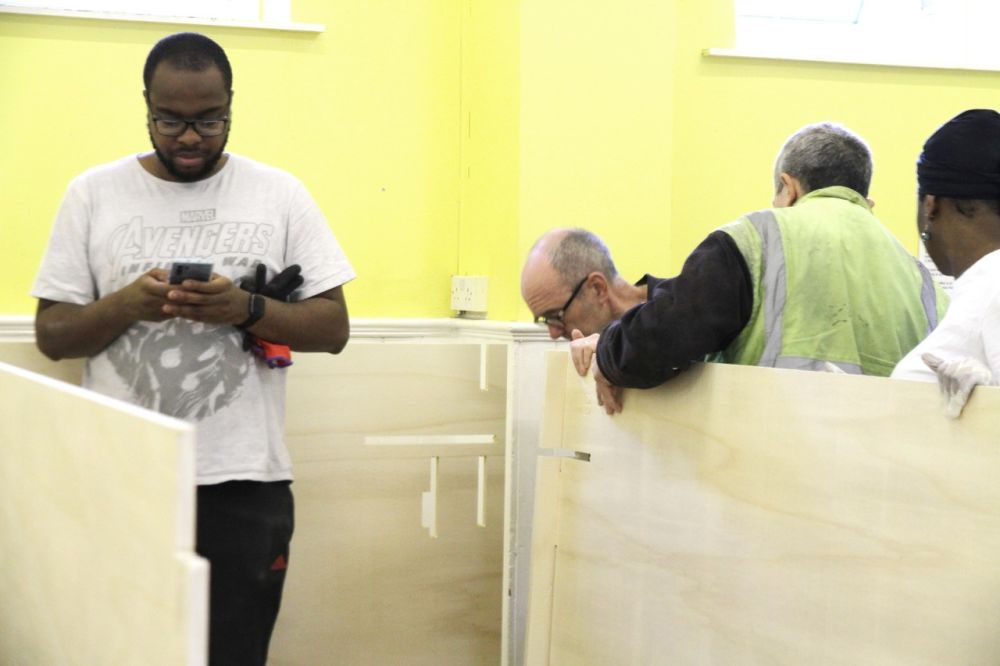 People building wooden sleeping pods