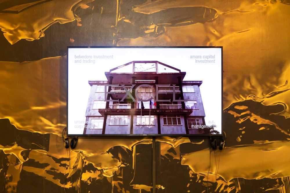  Screen showing outside of a building with words 'Excel' across it. Gold and brown wallpaper in an effect that resembles honey.