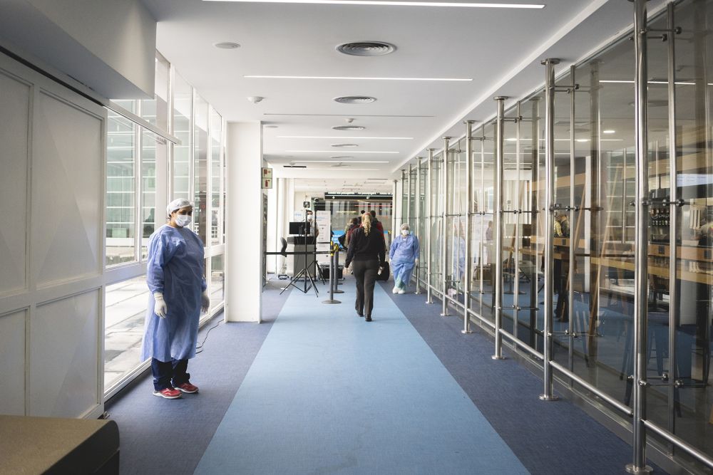 people wearing scrubs and masks at airport