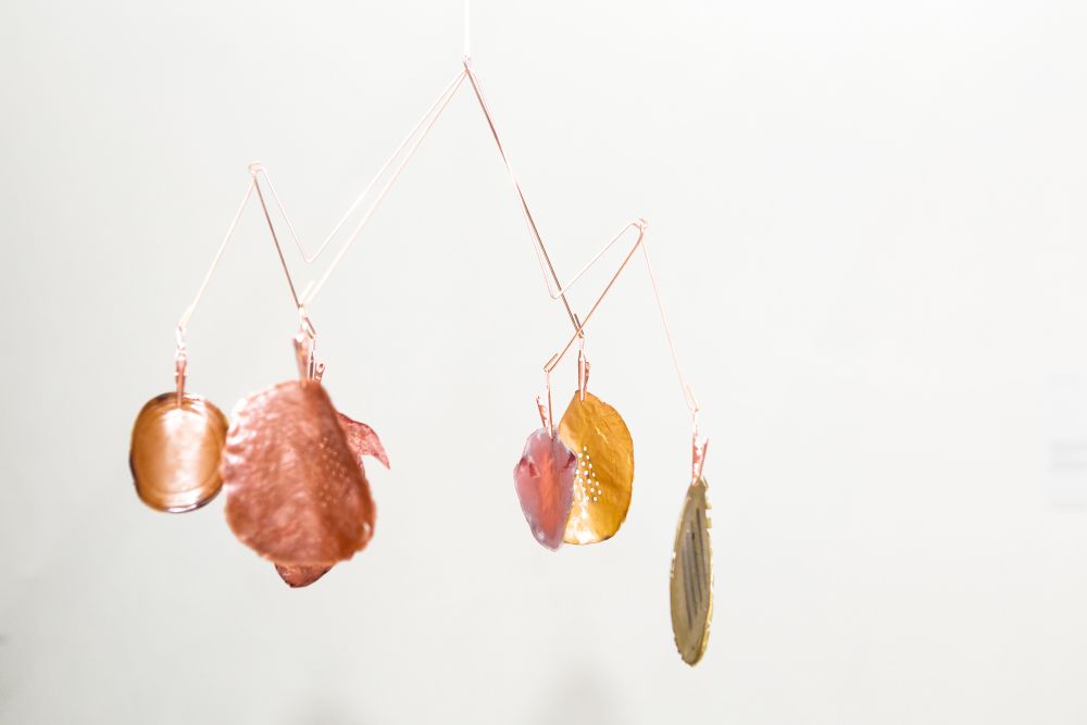 Piece of work showing various hanging abstract shapes.