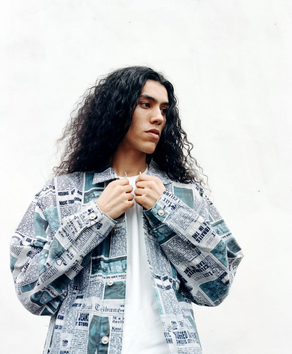 Photograph of a young man with long curly hair