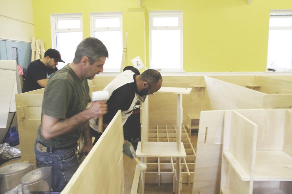 People building wooden sleeping pods