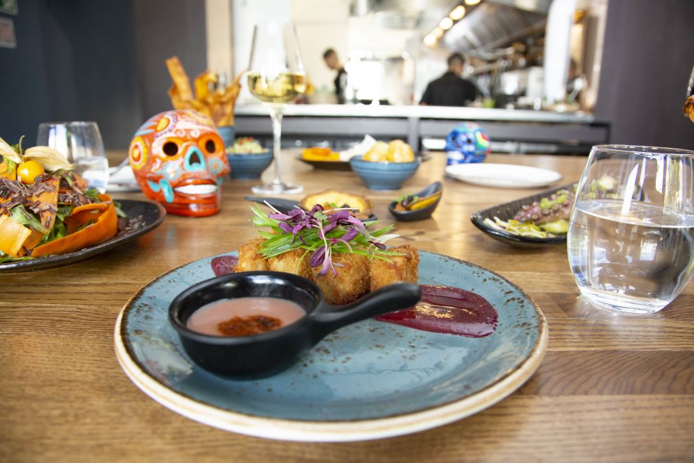 Dish at Paladar and other food on a table.