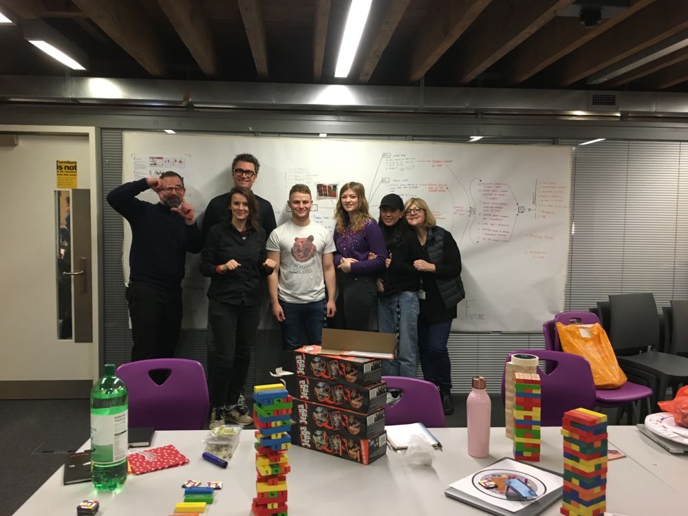 People standing with coloured blocks on table
