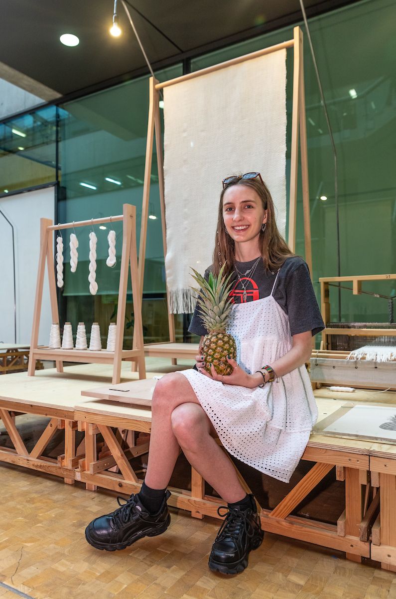 Portrait of woman holding a pineapple