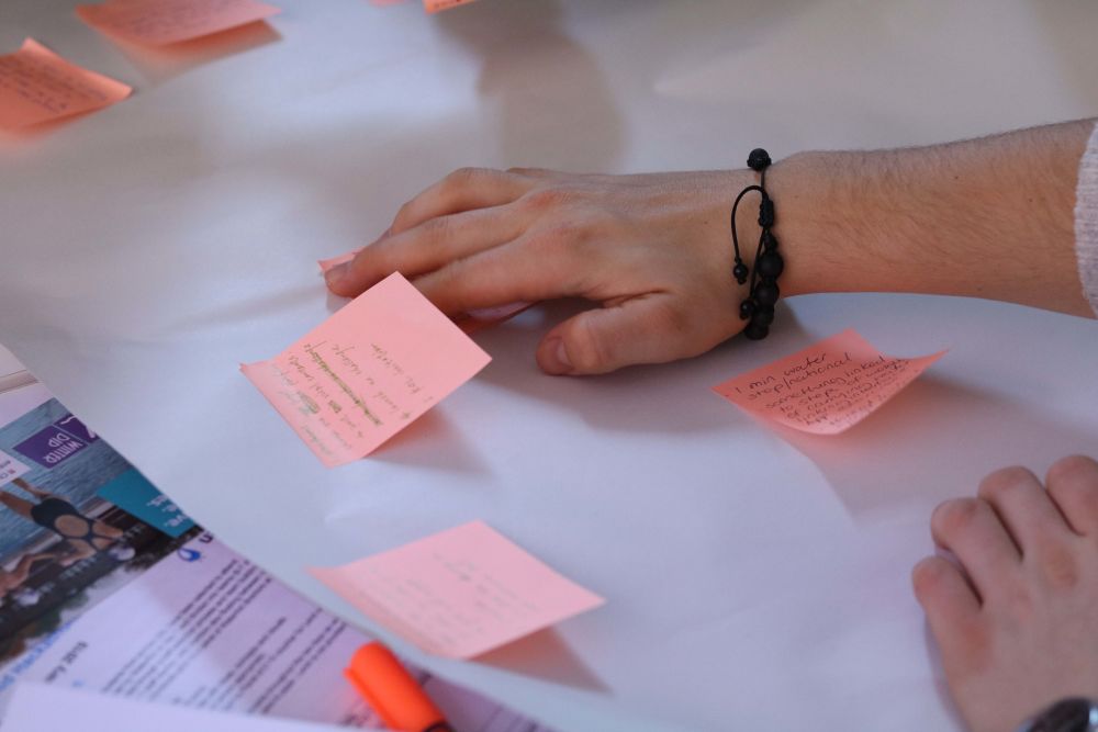 Post it notes on the table with notes from WaterAid workshop
