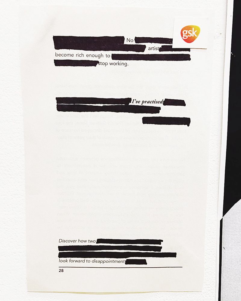 Document with blacked out text. Reads: 