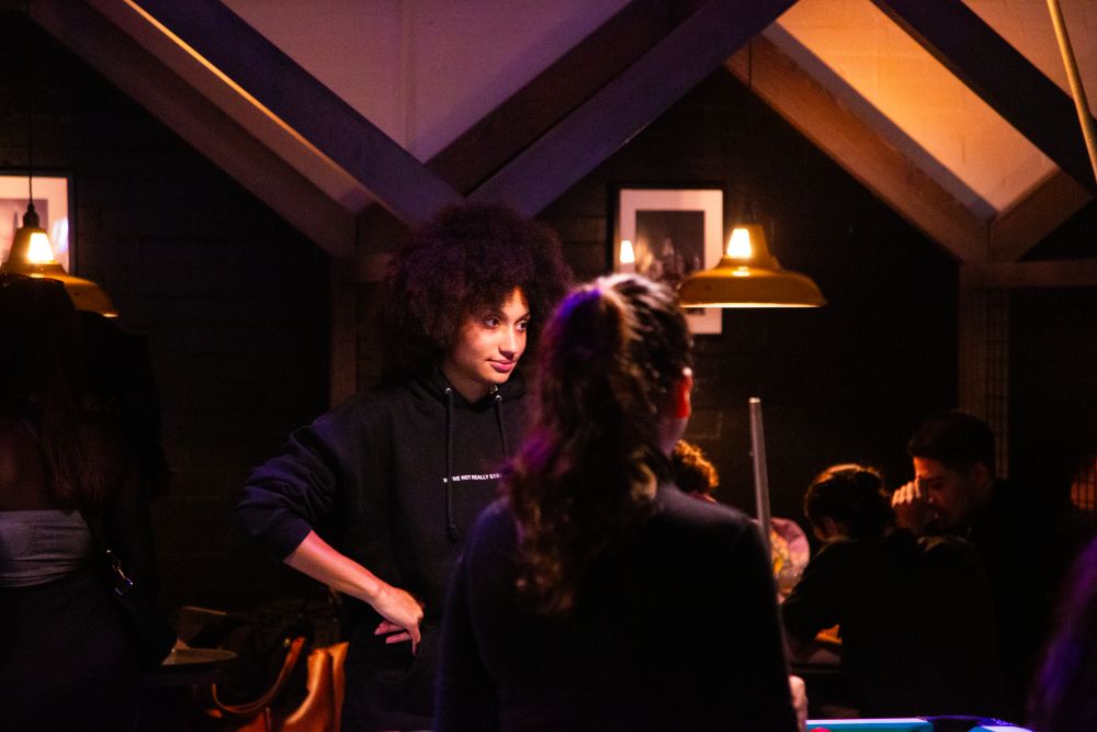 Student spotlighted in the bar area