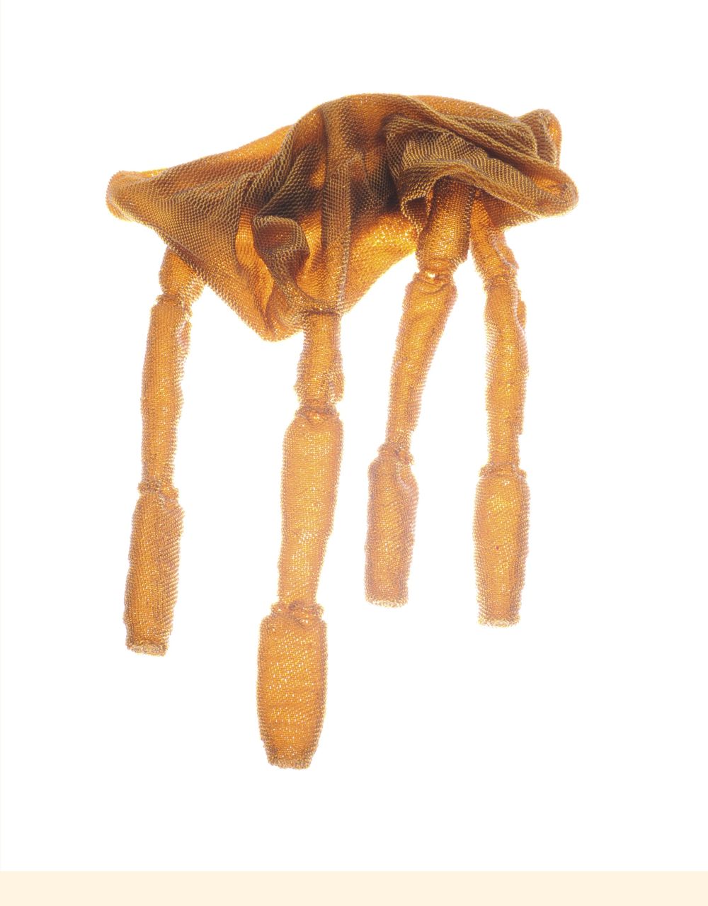 An abstract shape made from a copper coloured material