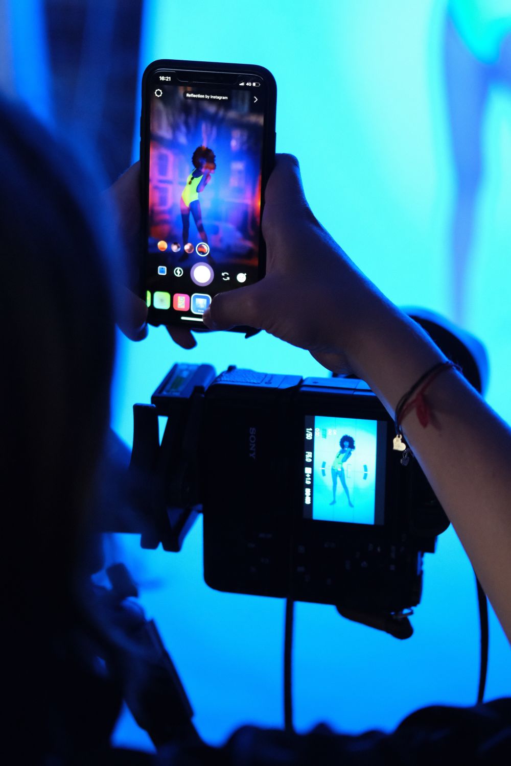 Person taking photo of set with iphone