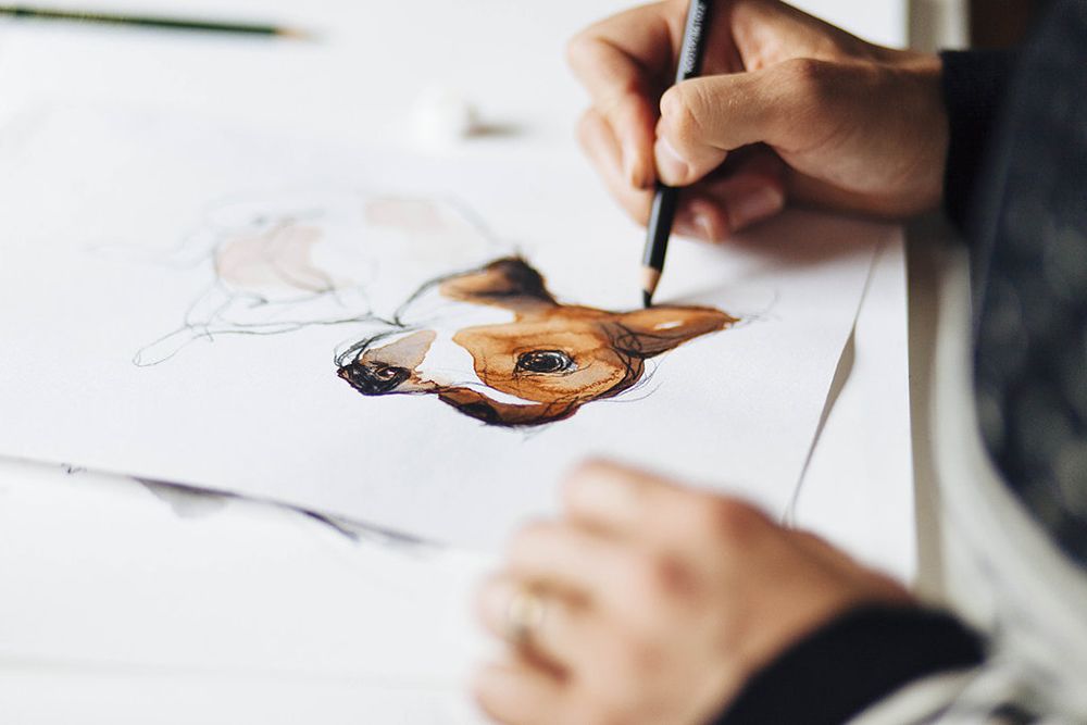 Hand resting on paper, drawing.