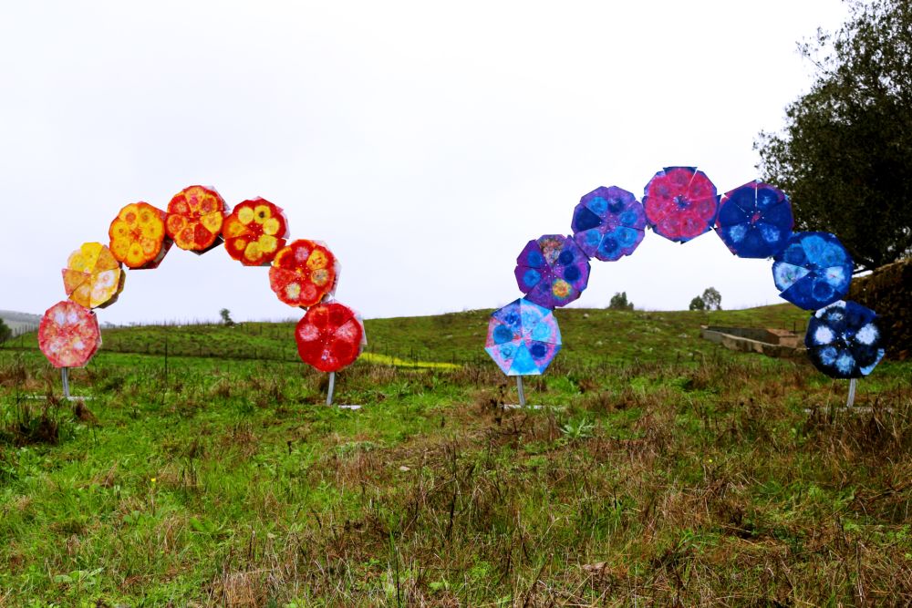 two plastic arch sculptures in a field