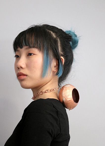 Copper vessel sitting on the back of a neck