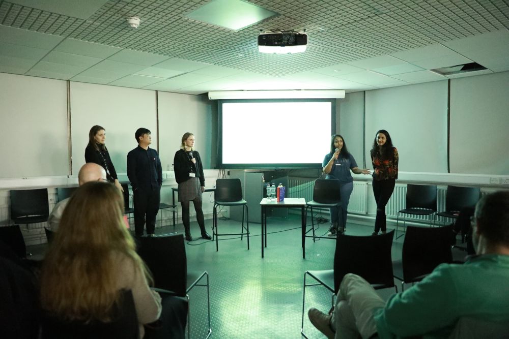 Student team addressing the crowd at symposium.