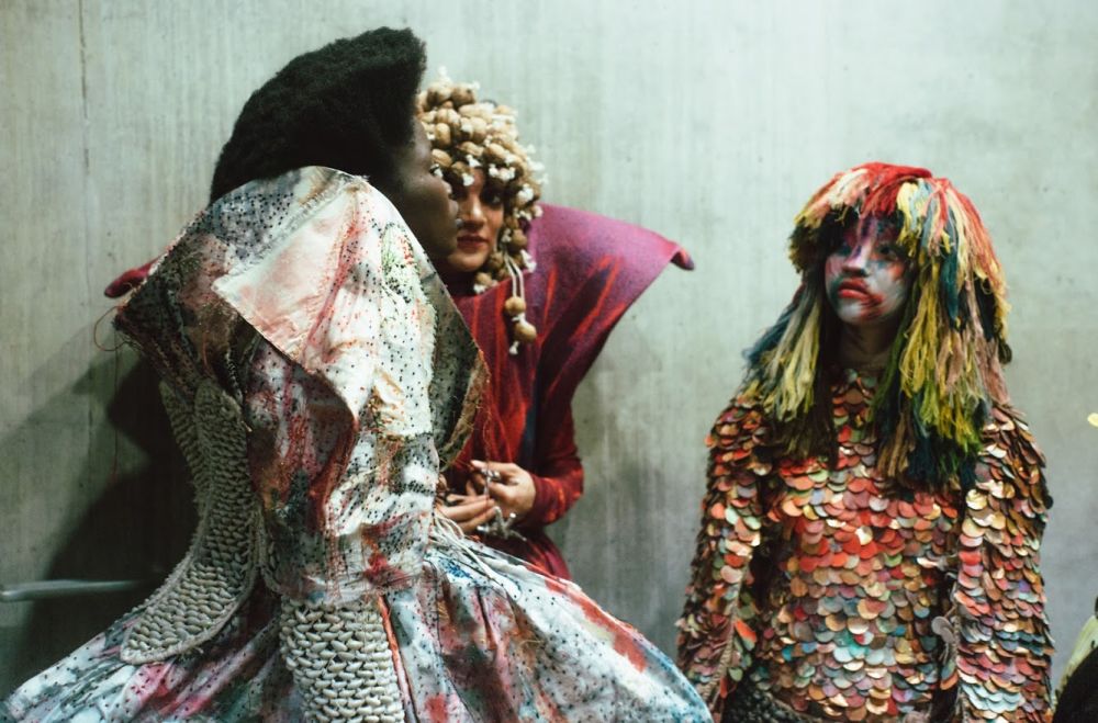 Three models wearing a range of detailed garments