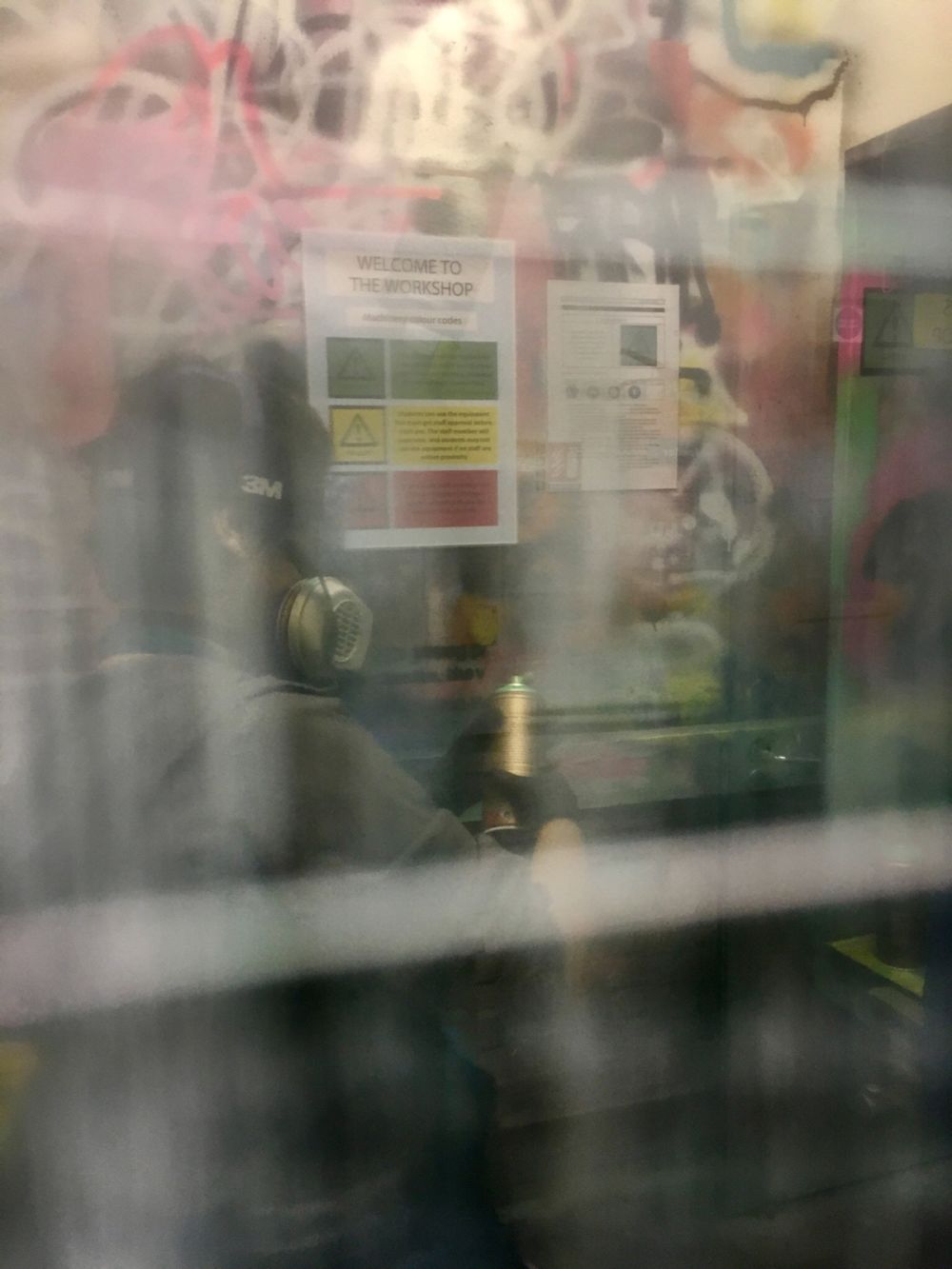Student using spray can during work in progress