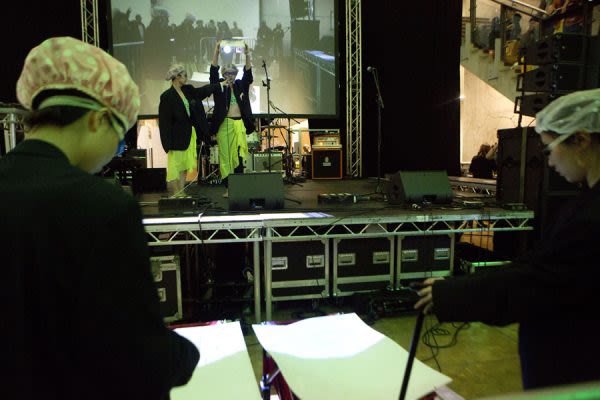 A photograph of two people performing on a stage 