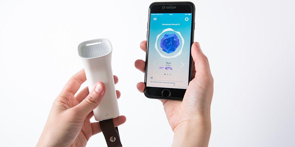 A pair of hands holding a phone which shows an interface and a breathing tool