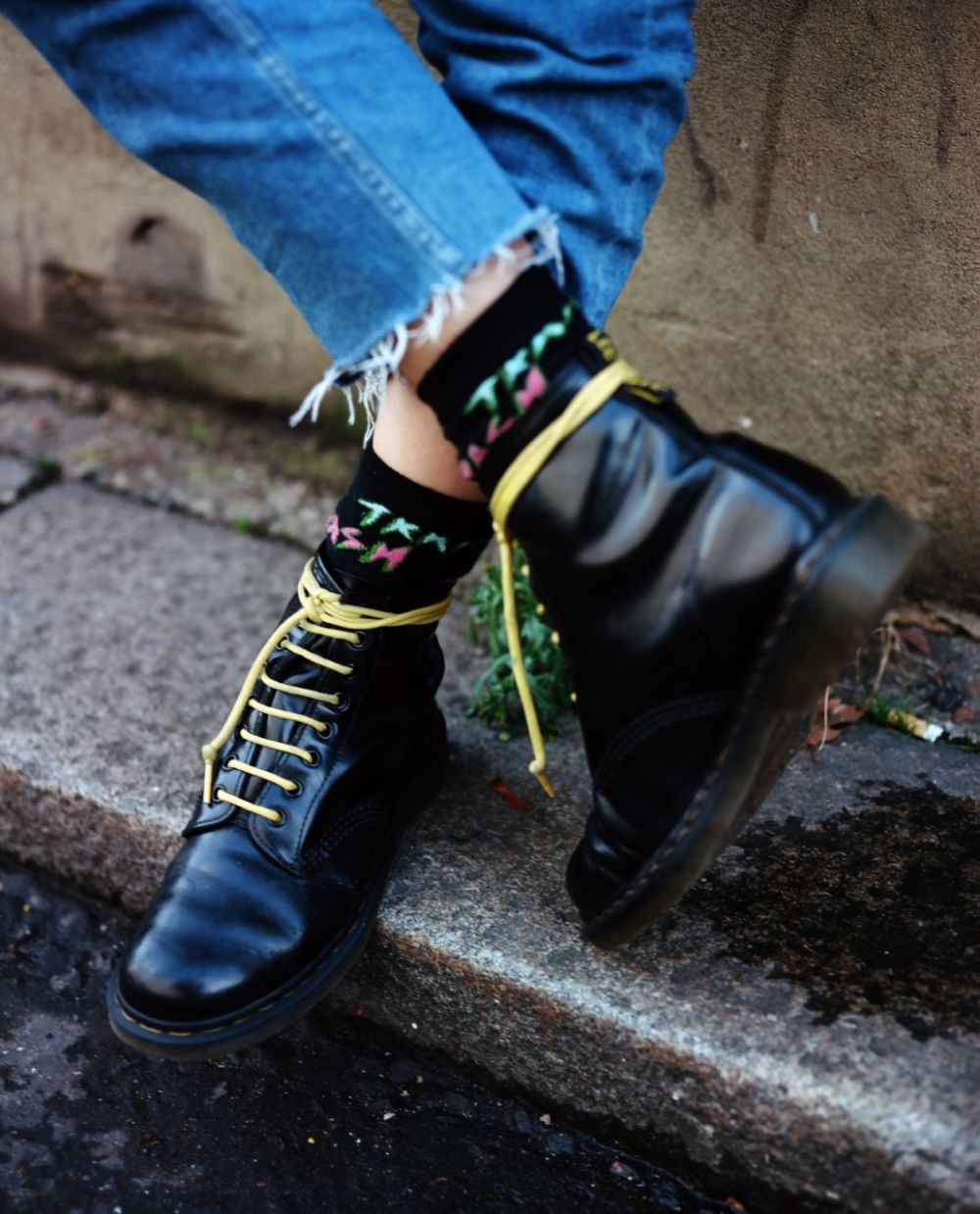 Close up shot of boots with yellow laces
