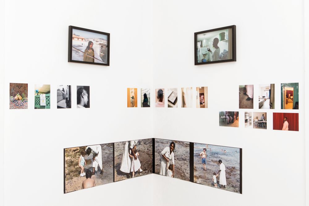 Two walls covered with photographic work.