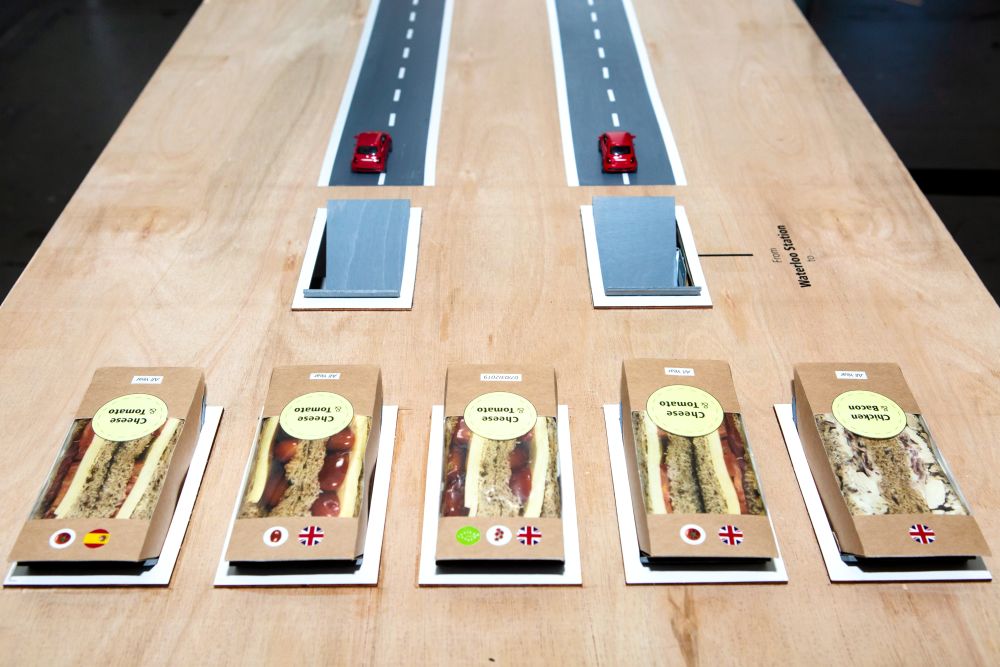 Work showing five different flavours of sandwiches and the origins of their ingredients and two racing toy cars.
