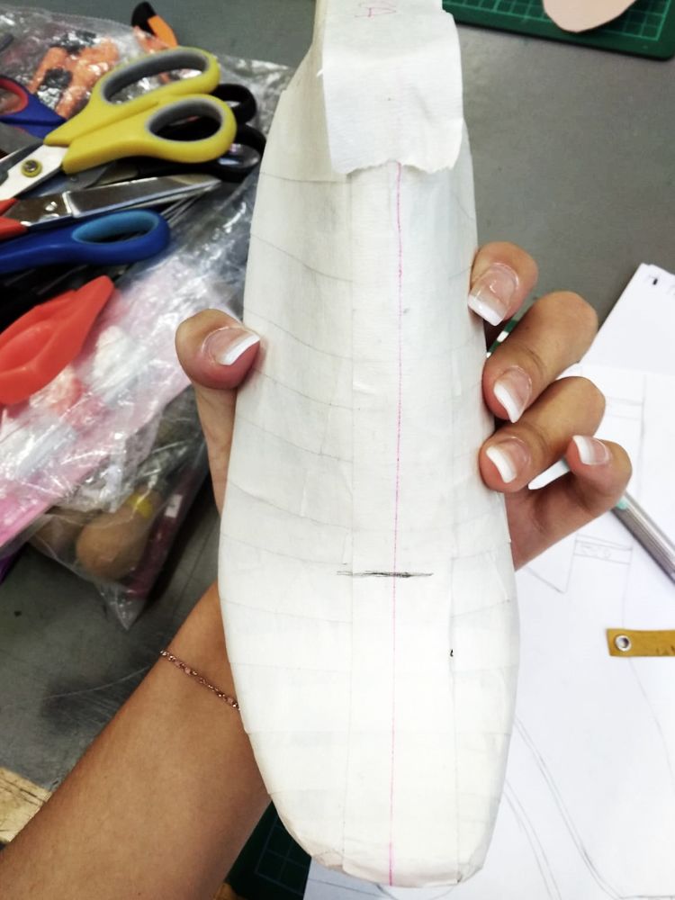 Paper wrapped around a last, shoe design making in progress.