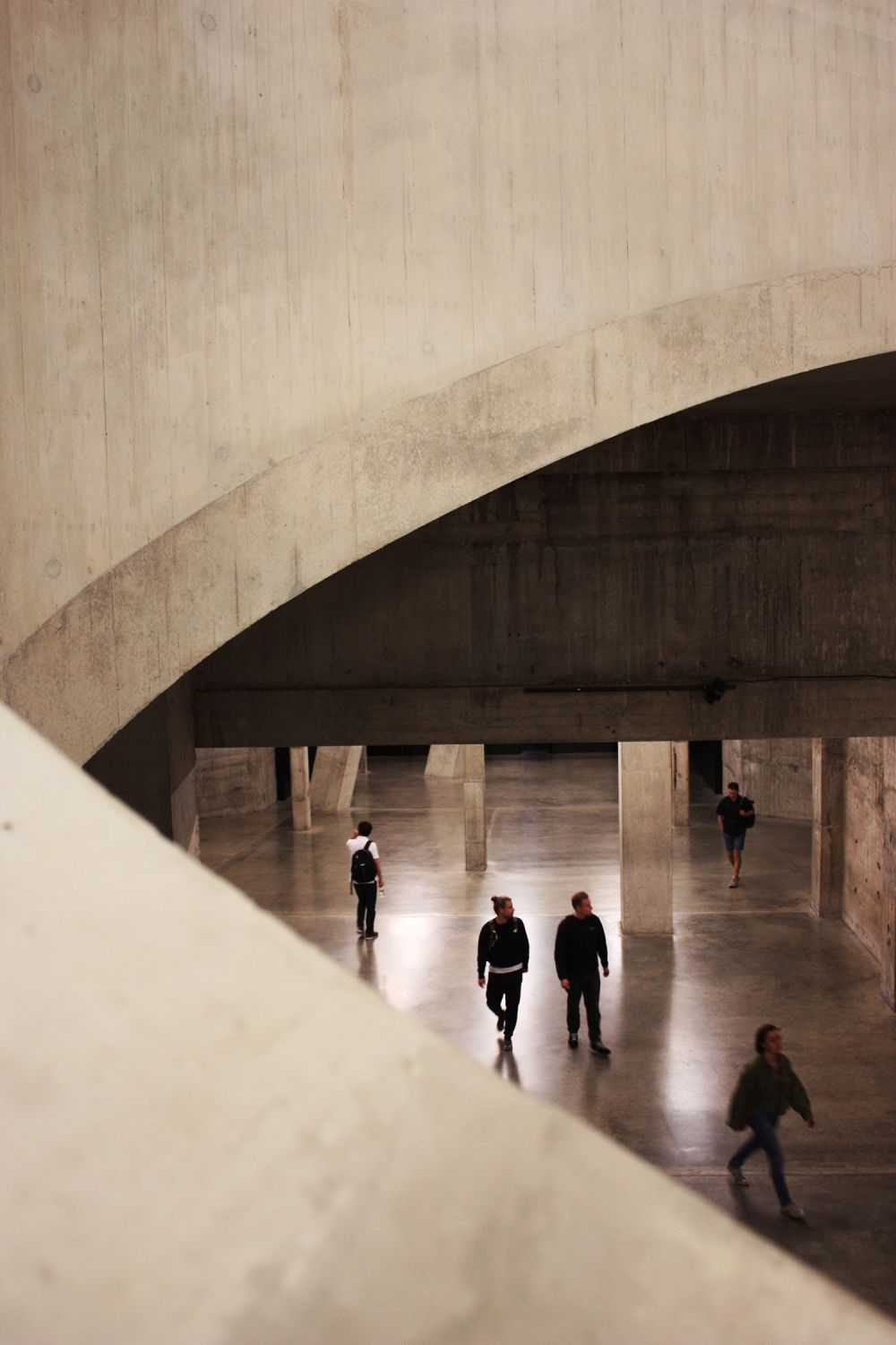 the interiors of the tate modern you can see two people walking