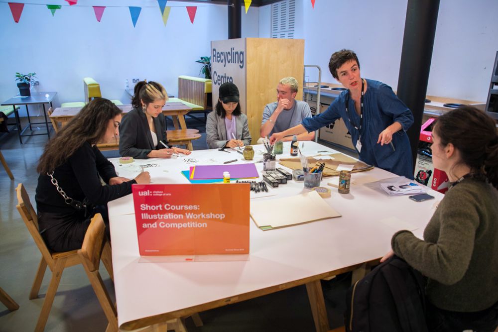 Tutor Leading an Illustration workshop around a table