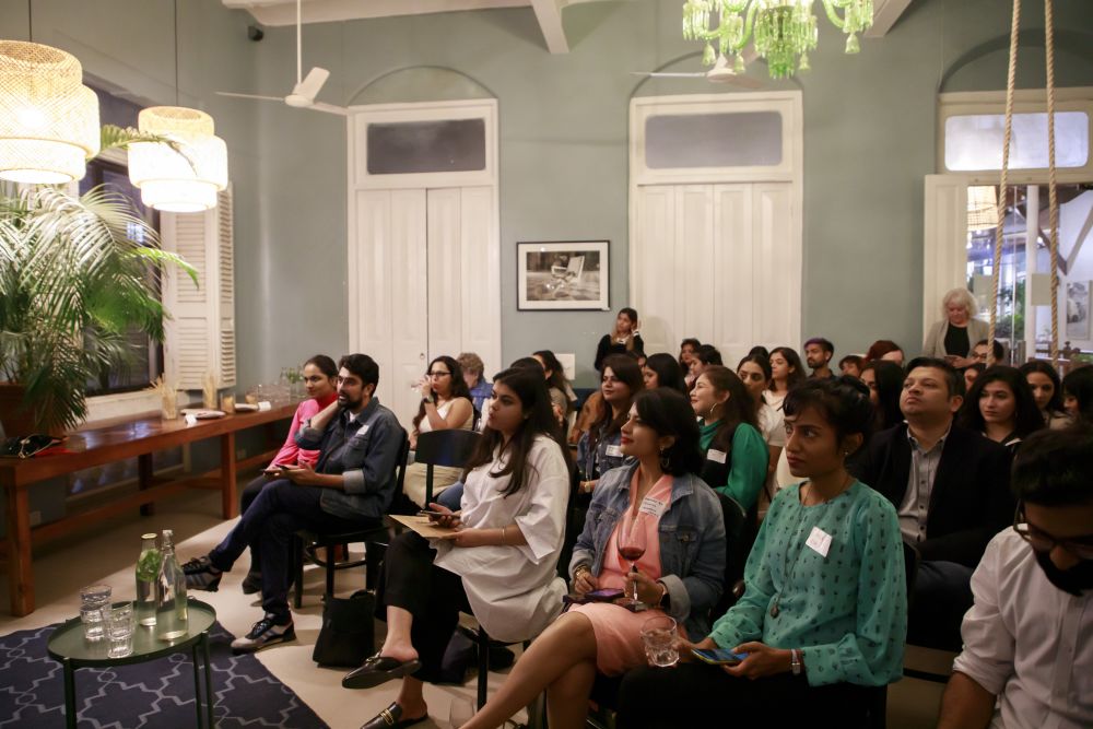 Photo of people sitting down, listening to a talk